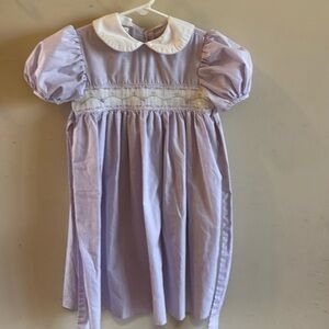 Smocked purple dress with Peter Pan collar. Purple gingham